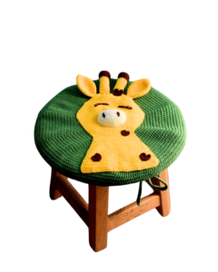 Wooden children's chair with a crocheted cover featuring 'Dotty' the giraffe, showcasing vibrant colors and playful design for a child's room.